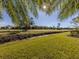 Landscaped yard with view of golf course at 936 Capri Isles Blvd # 102, Venice, FL 34292