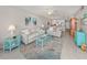 Bright living room with light beige sofas, teal accents, and coastal decor at 936 Capri Isles Blvd # 102, Venice, FL 34292