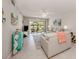 Living room with sofas, coastal decor, and sliding glass doors to patio at 936 Capri Isles Blvd # 102, Venice, FL 34292