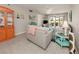 Living room with sofas, coastal decor, and sliding glass doors to patio at 936 Capri Isles Blvd # 102, Venice, FL 34292