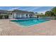 Community pool with surrounding patio at 936 Capri Isles Blvd # 102, Venice, FL 34292