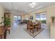 Bright dining room with seating for four and access to the backyard at 101 Tiziano Way, North Venice, FL 34275