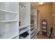 Large walk-in closet with ample shelving and drawers at 1104 Auburn Cove Cir, Venice, FL 34292