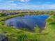 Community lake view with lush landscaping at 11204 Mcdermott Ct # 11204, Englewood, FL 34223