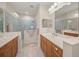 Elegant bathroom with dual sinks, walk-in shower, and updated vanity at 11204 Mcdermott Ct # 11204, Englewood, FL 34223