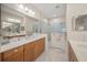 Bathroom features dual sinks, walk-in shower, and stylish finishes at 11204 Mcdermott Ct # 11204, Englewood, FL 34223