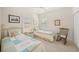 Charming bedroom with twin beds, built-in shelving, and window seating at 11204 Mcdermott Ct # 11204, Englewood, FL 34223