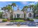 Community clubhouse with palm trees and landscaping at 11204 Mcdermott Ct # 11204, Englewood, FL 34223