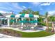 Outdoor patio area with tables, umbrellas, and landscaping at 11204 Mcdermott Ct # 11204, Englewood, FL 34223