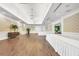 Large community room with hardwood floors and white linens at 11204 Mcdermott Ct # 11204, Englewood, FL 34223