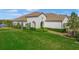 Luxury home exterior with landscaped lawn and lake views at 11204 Mcdermott Ct # 11204, Englewood, FL 34223