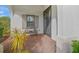 Inviting front porch with bench and brick flooring at 11204 Mcdermott Ct # 11204, Englewood, FL 34223