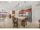 Open kitchen with island, stainless steel appliances, and views to the living room at 11204 Mcdermott Ct # 11204, Englewood, FL 34223