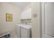 Bright laundry room with washer, dryer, and cabinets at 11204 Mcdermott Ct # 11204, Englewood, FL 34223