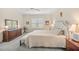 Bright main bedroom with plush bed, ample natural light, and large window at 11204 Mcdermott Ct # 11204, Englewood, FL 34223