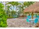 Relaxing poolside seating under a thatched palapa at 11204 Mcdermott Ct # 11204, Englewood, FL 34223