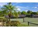 Well-maintained tennis court surrounded by palm trees at 11204 Mcdermott Ct # 11204, Englewood, FL 34223