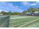 Tennis court with green surface and surrounding fence at 11204 Mcdermott Ct # 11204, Englewood, FL 34223
