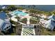 Aerial view of community pool and clubhouse with landscaping at 11571 Gleaming Ter, Venice, FL 34293