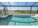 Relaxing pool and spa with screened enclosure and backyard view at 11571 Gleaming Ter, Venice, FL 34293