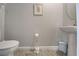 Bright half-bathroom with wood-look tile flooring and neutral colored walls at 11842 Sistine Ln, Venice, FL 34293