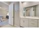 Bathroom with double vanity, white cabinets, and a large mirror at 11842 Sistine Ln, Venice, FL 34293