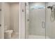 Bathroom with glass shower, toilet and small window at 11842 Sistine Ln, Venice, FL 34293