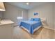 Bright bedroom featuring a cozy bed and carpet, complemented by a modern ceiling fan at 11842 Sistine Ln, Venice, FL 34293