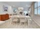 Bright dining area with a large table, stylish decor, and plenty of natural light at 11842 Sistine Ln, Venice, FL 34293