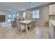 Open-concept dining and living area with a large dining table, and comfortable seating at 11842 Sistine Ln, Venice, FL 34293