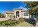 Charming single-story home featuring a tile roof, manicured landscaping, and an attached two-car garage at 11842 Sistine Ln, Venice, FL 34293