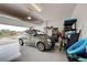 Spacious two car garage featuring a finished epoxy floor, storage and a charming vehicle at 11842 Sistine Ln, Venice, FL 34293