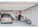 Spacious two car garage featuring a finished epoxy floor, storage and a charming vehicle at 11842 Sistine Ln, Venice, FL 34293