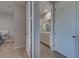 Hallway view into the bathroom with double doors that features tile flooring and a modern vanity at 11842 Sistine Ln, Venice, FL 34293