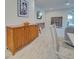 Hallway view showcasing modern decor with artwork, sleek furnishings, and wood-look flooring at 11842 Sistine Ln, Venice, FL 34293