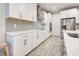 Well-designed kitchen with ample counter space, stainless steel appliances, and white cabinets at 11842 Sistine Ln, Venice, FL 34293
