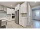 Stylish kitchen featuring stainless steel appliances, white cabinets, and a gray tile backsplash at 11842 Sistine Ln, Venice, FL 34293