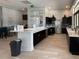 Resident kitchen with stainless steel appliances, a large island, and elegant countertops at 11842 Sistine Ln, Venice, FL 34293