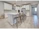 Bright, modern kitchen with a large island, stainless steel appliances, and stylish bar stools at 11842 Sistine Ln, Venice, FL 34293