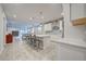 A spacious open kitchen featuring a large island with bar seating and modern stainless steel appliances at 11842 Sistine Ln, Venice, FL 34293