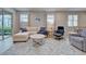 Inviting living room with a comfortable sectional, decorative rug, and view of the outdoor patio at 11842 Sistine Ln, Venice, FL 34293