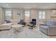 Comfortable living room with a plush sectional sofa, stylish armchairs, and a bright area rug at 11842 Sistine Ln, Venice, FL 34293