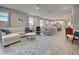 Spacious living room offering an open floor plan with a view of the modern kitchen and dining area at 11842 Sistine Ln, Venice, FL 34293