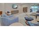 Stylish living room featuring comfortable seating, modern furniture, and sliding glass doors to the pool area at 11842 Sistine Ln, Venice, FL 34293