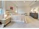 Bright and airy main bedroom featuring neutral colors, tray ceilings, and carpeted floors at 11842 Sistine Ln, Venice, FL 34293