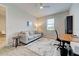 Office space with a couch and decorative pillows, a patterned rug, desk, and modern ceiling fan at 11842 Sistine Ln, Venice, FL 34293