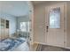 Office space visible from the entryway through open french doors, showcasing a comfortable workspace at 11842 Sistine Ln, Venice, FL 34293