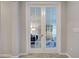 A stylish set of French doors leads into the office area with beautiful decor at 11842 Sistine Ln, Venice, FL 34293