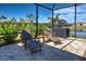 Comfortable outdoor seating on a paved patio provides a place to relax while viewing the water at 11842 Sistine Ln, Venice, FL 34293