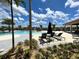 Resort-style pool with lounge chairs and a covered cabana providing a luxurious relaxation spot at 11842 Sistine Ln, Venice, FL 34293